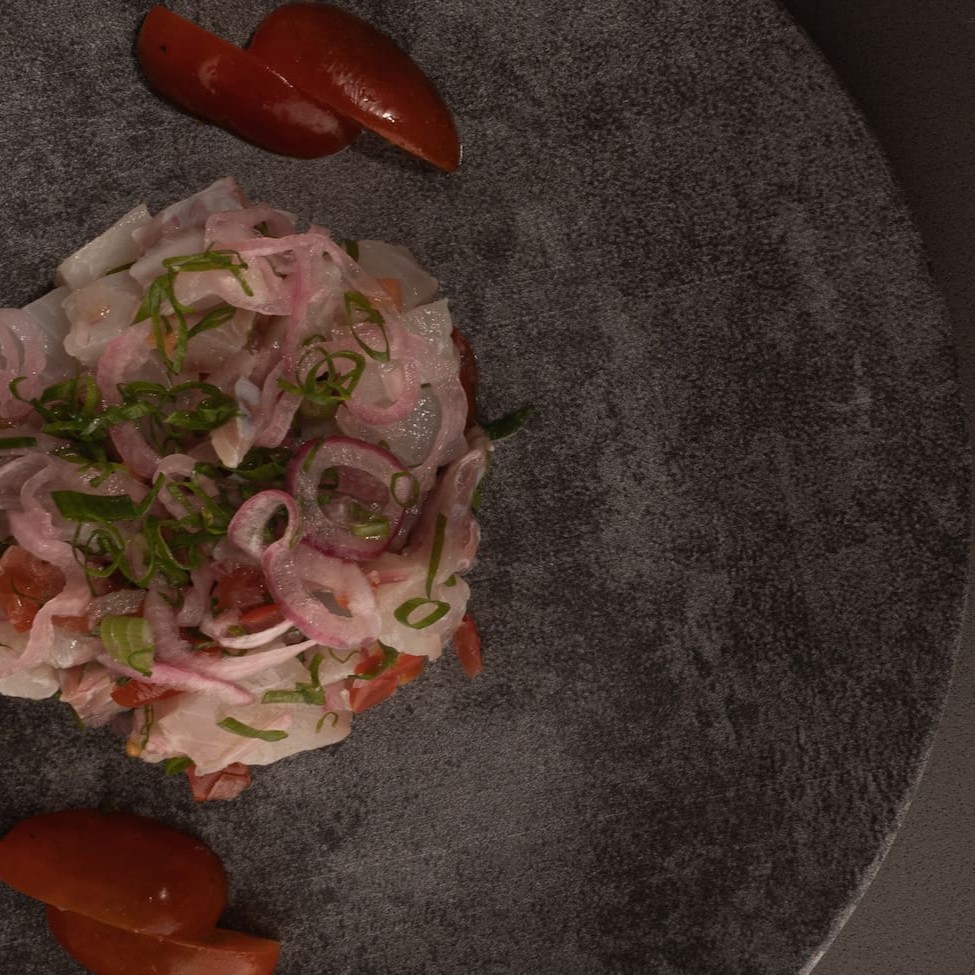 Cubos de peixe branco, fios de cebola roxa, Tomazinho cereja, pimentinha dedo de moça, pimenta togarashi, coentro, sal e azeite.