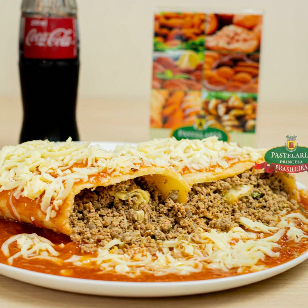 Panqueca de aproximadamente 650 gramas, coberta com molho de tomate e queijo derretido, recheada com carne moída.