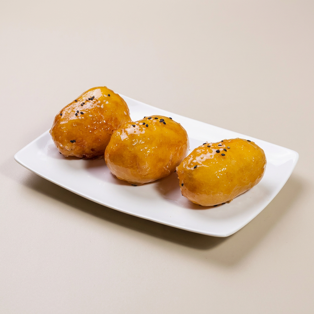 8 pedaços de banana empanadas, caramelizadas e finalizadas com gergelim torrado