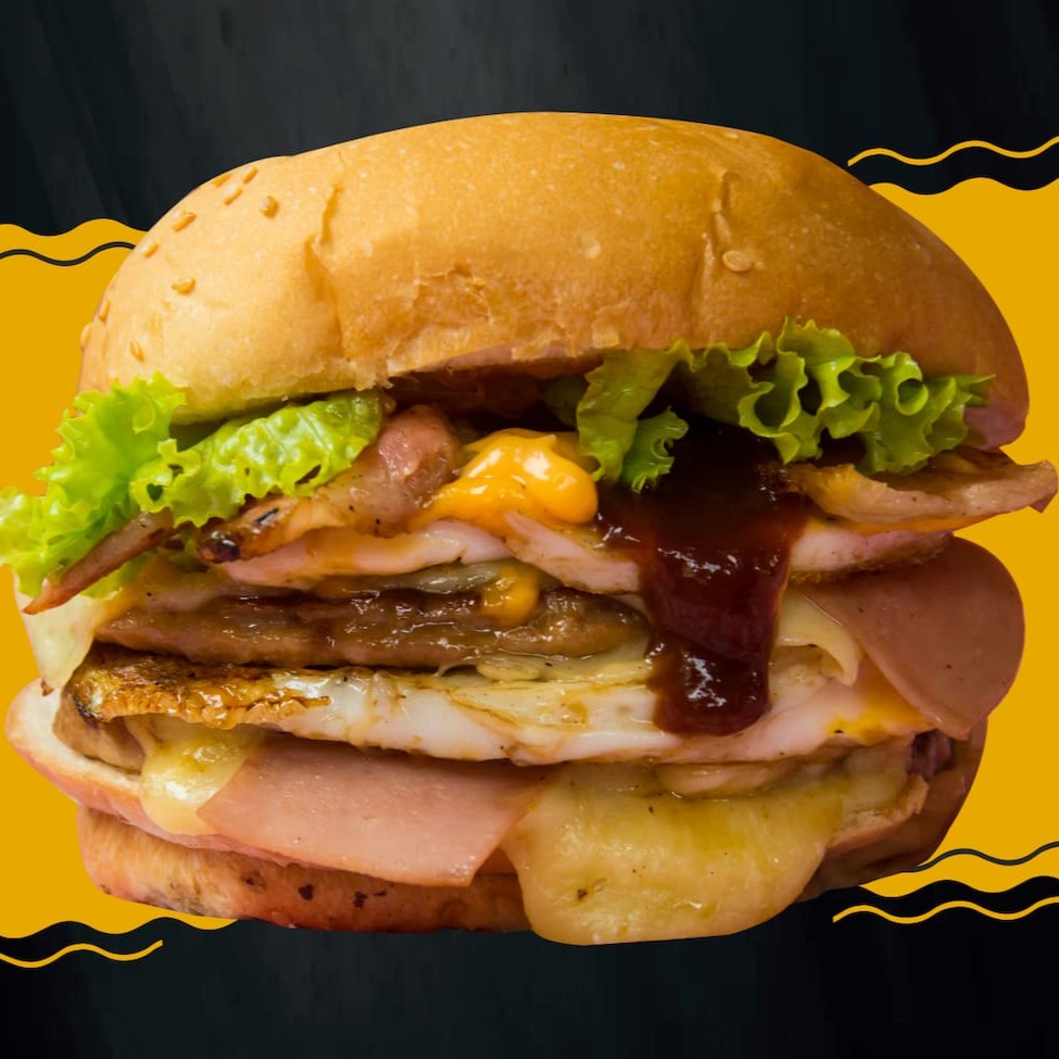 Pão com gergelim, 2 carnes, 2 ovos, queijo, presunto, bacon, salada, molho billy jack sabor cheddar, barbecue.