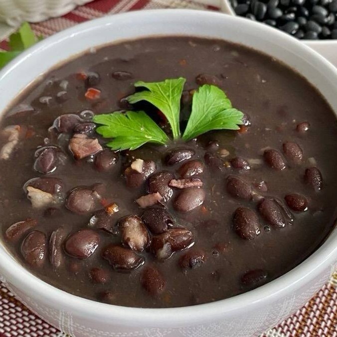 Feijão Preto Caseiro Sabor tradicional e irresistível! Nosso feijão preto é preparado com temperos especiais, cozido lentamente até ficar cremoso e cheio de sabor. Acompanha perfeitamente qualquer prato e traz aquele gostinho de comida feita em casa.