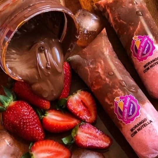 Este primoroso sacolé apresenta uma massa extremamente cremosa, que exala o doce e vibrante sabor do morango, a fruta mais adorada da nossa clientela. Para acentuar ainda mais a experiência, cada sacolé é generosamente recheado com a suave e rica Nutella. É uma criação divina que promete deleitar o seu paladar e fazer você se apaixonar à primeira mordida!