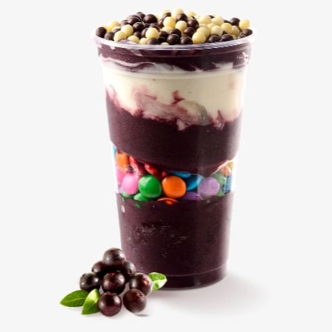 Um delicioso copo de açaí batido com morango, servido bem gelado. A mistura tem uma textura cremosa e uma cor vibrante que combina o roxo escuro do açaí com toques dos morangos frescos. Uma bebida perfeita para refrescar e saborear!