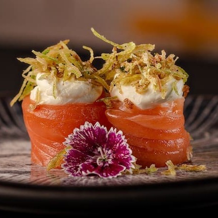 Joy de salmão é uma bolinha de arroz enrolado com neta de salmão por volta recheado com creame chessee e alho poró