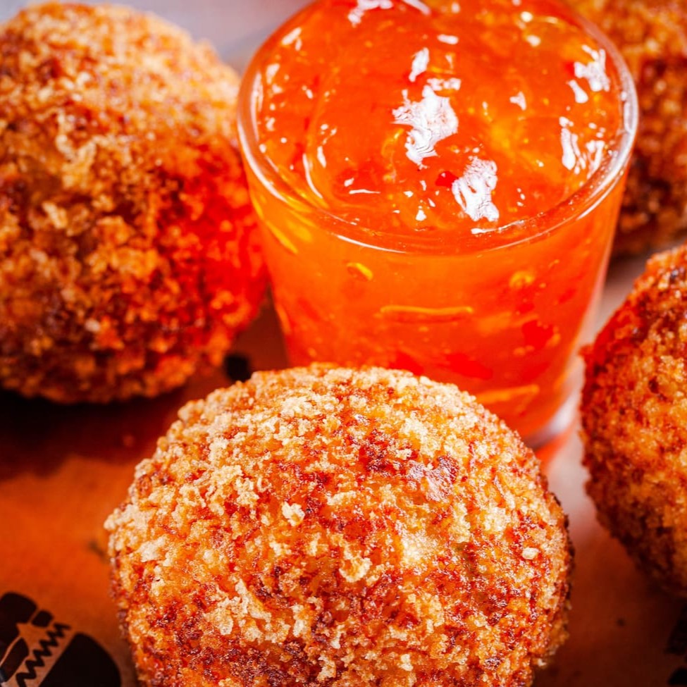 Bolinha de frango sem massa, especiarias, recheada com farofa de bacon e Cream Cheese, Empanada na farinha Panko. Acompanha geléia de pimenta. (4 unidades)