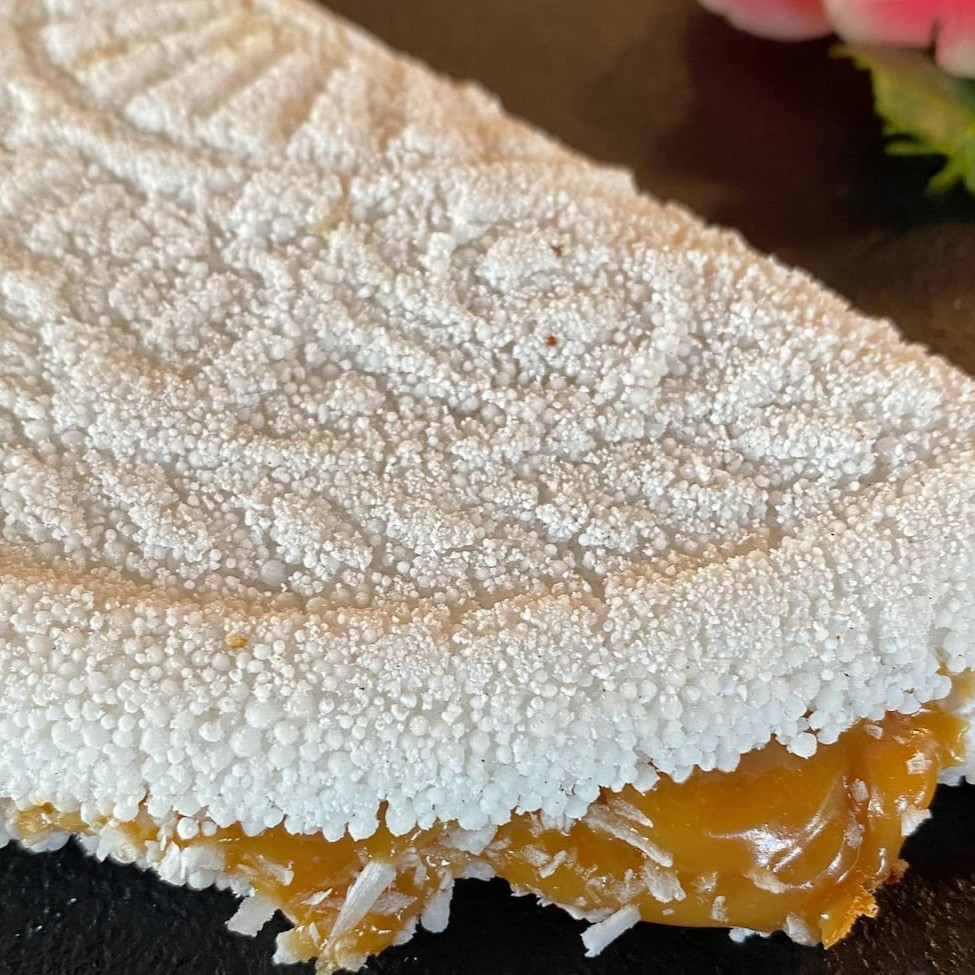 Uma combinação doce e envolvente que traz o melhor da tradição nordestina. Feito com coco ralado fresco e finalizado com doce de leite cremoso. Uma escolha perfeita para quem busca uma sobremesa regional com sabor marcante e textura irresistível.