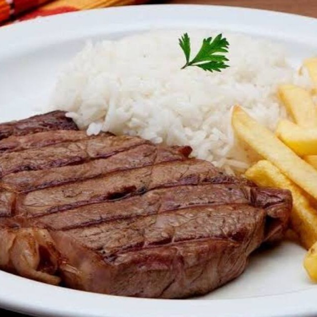 'Bife de Picanha na Manteiga ao Alho' é o prato principal das 'Especialidades do Rosário'. Este prato é cuidadosamente preparado com um suculento bife de picanha, frito na manteiga ao alho, liberando aromas irresistíveis. Acompanha um arroz soltinho, um feijão caseiro bem temperado, batatas fritas crocantes, farofa saborosa e uma salada fresca e colorida.