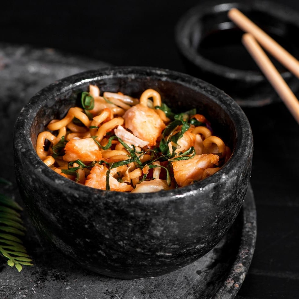 Macarrão oriental refogado com frango, cenoura, acelga, couve, repolho roxo e repolho verde, finalizado com shoyu, óleo de gergelim e cebolinha