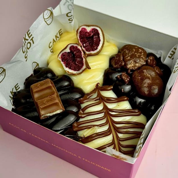 4 pedaços de brownies fudge super chocolatudo com coberturas variadas - Brigadeiro branco com Franuí, Brigadeiro de chocolate com Rocks de Ovomaltine, Brigadeiro Branco com riscos de Nutella, Brigadeiro de chocolate com Kinder Chocolate :) ~Não escrevemos Bilhetes sem a compra do mesmo que está disponível no começo e final do cardápio. A Cake Shot não altera e/ou adiciona ingredientes aos produtos já formulados. - 290g Brownie de chocolate - brigadeiro branco - Brigadeiro de chocolate - Brownie - Kinder - Nutella - Ovomaltine - Framboesa