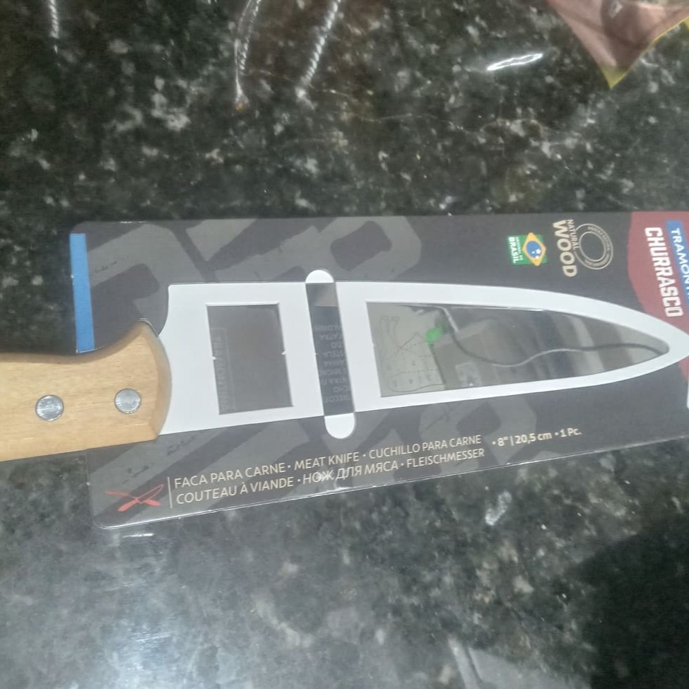 "Faca Para Carne Tramontina Churrasco Com Laminas Em Aço Inox E Cabo De Madeira Natural 8"" Faca para Carne Tramontina Churrasco com Lâminas em Aço Inox e Cabo de Madeira Natural 8 Com a Faca para Carne Tramontina Churrasco com Lâminas em Aço Inox e Cabo de Madeira Natural 8 Polegadas, servir seus convidados será ainda mais prático e saboroso. Com lâmina de aço inox, ela garante maior durabilidade do fio de corte devido ao tratamento térmico. Além disso, o cabo de madeira natural dá um toque sofisticado na hora de servir. Seu churrasco será um sucesso com essa faca cheia de estilo.  Lâmina de aço inox com maior durabilidade do fio devido ao tratamento térmico. Cabo de madeira natural. Rebites de alumínio."