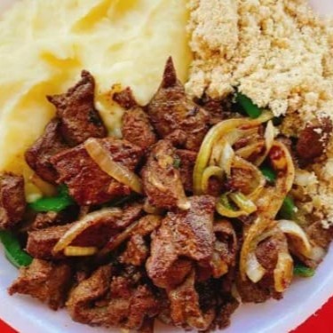 Apresentamos nosso delicioso 'Fígado com Purê de Batatas', uma opção de destaque em nosso Cardápio Promocional. Este prato é cuidadosamente preparado, trazendo o sabor singular do fígado, bem temperado e cozido à perfeição. Acompanhado de um suave e cremoso purê de batatas, ele cria uma combinação de sabores inigualável. Além disso, é servido com arroz branco soltinho, feijão fresquinho e farofa crocante. Uma mistura de texturas e sabores que proporciona uma experiência culinária única. Venha experimentar!