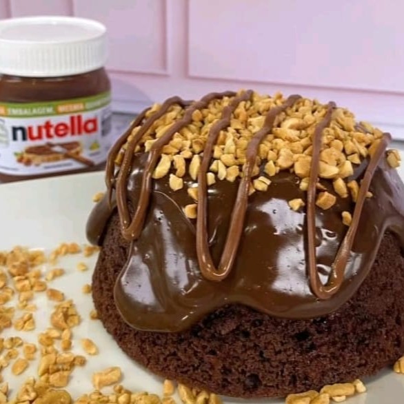Bolo de massa fofinha e molhadinha de chocolate coberta com recheio bem cremoso de brigadeiro 50% cacau, finalizado com amendoim picados e fios de Nutella.