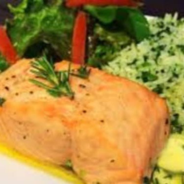 Filé de salmão grelhado é acompanhado de arroz de brócolis e salada verde.