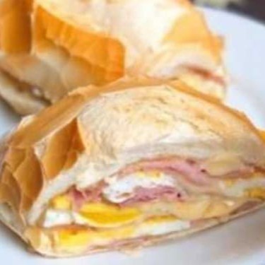 Aventure-se no sabor irresistível do nosso 'Misto com Ovo no Pão Francês'. Este lanche é um clássico aprimorado à excelência com ingredientes de primeira linha. O pão francês, exibindo uma casca crocante e miolo suave, acolhe generosas camadas de queijo e presunto minuciosamente escolhidos, garantindo um sabor incomparável. Acrescentamos um ovo perfeitamente cozido para um toque extra de requinte. Cada mordida é uma experiência singular de sabor e textura, tornando este lanche a opção ideal para qualquer momento do Dia. Deixe-se seduzir pelo encanto do nosso 'Misto com Ovo