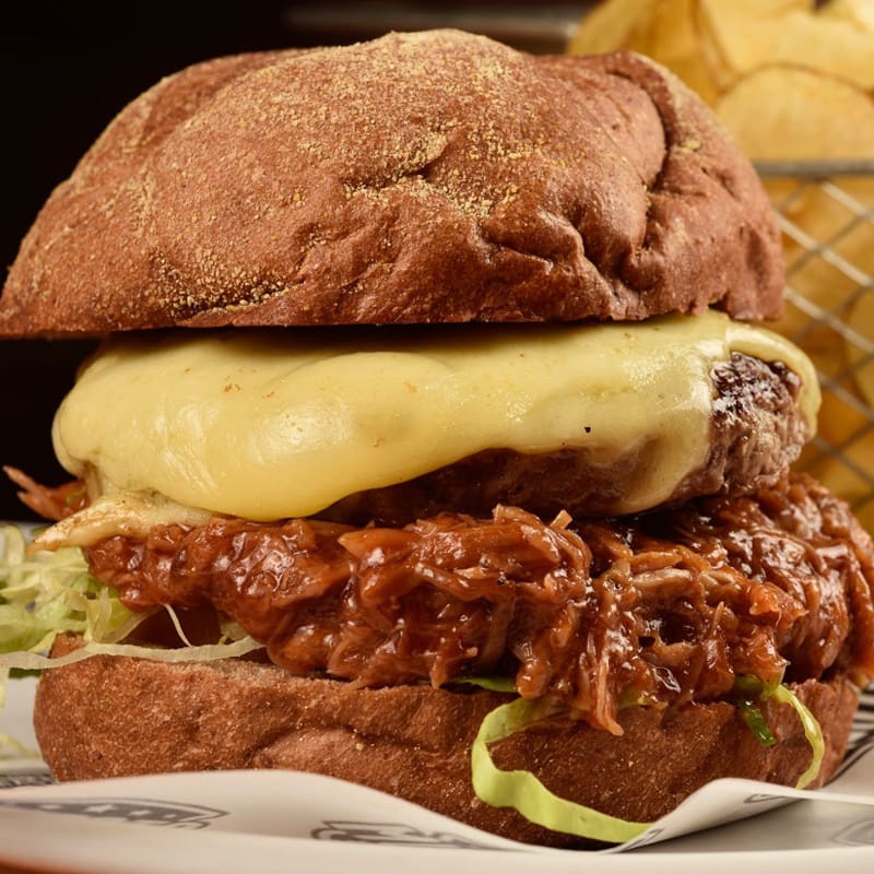 110g do saboroso hambúrguer stadium, pão australiano, maionese stadium, queijo mussarela, costela suína desfiada, molho barbecue, alface e tomate. Acompanha batata frita brazuca.