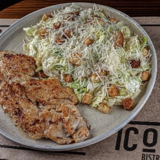 Peito de frango grelhado e salada caesar com croutons caseiro, parmesão fresco ralado e nosso delicioso molho aioli.  *O frango e a salada são servidos separadamente.*