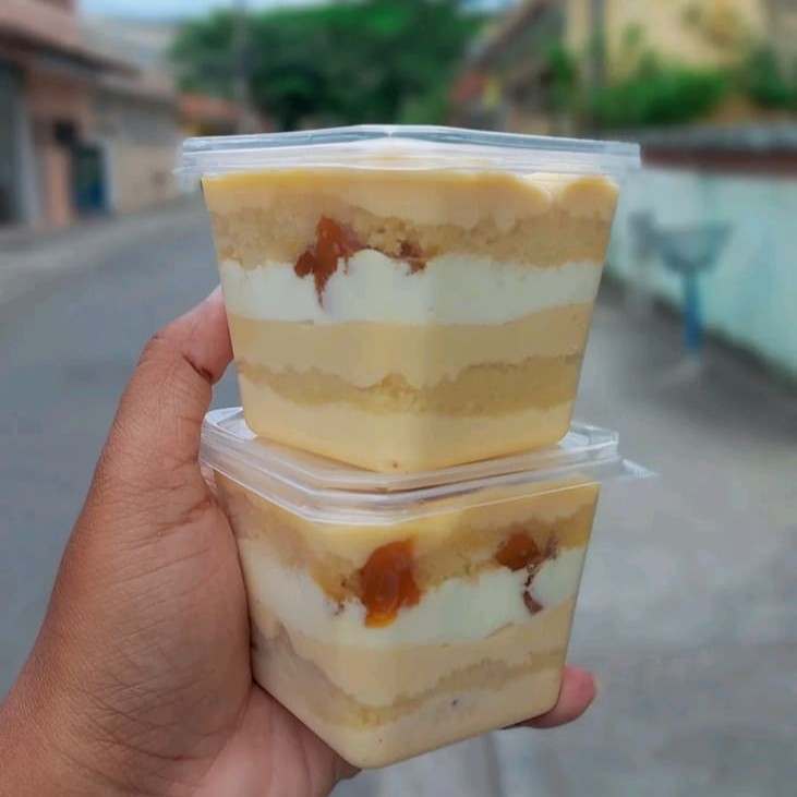 Um delicioso bolo de pote com Massa baunilha com recheio de Ninho com abacaxi e mousse de Ninho