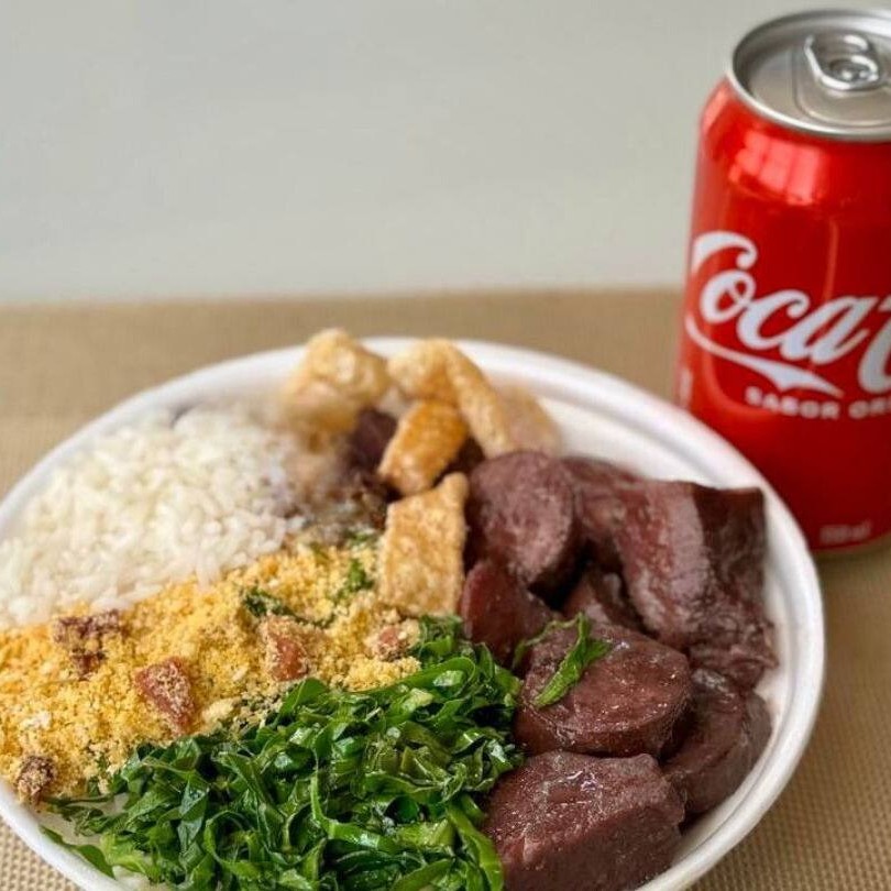 Marmita feijoada magra individual (arroz, costelinha, linguiça calabresa, paio, couve refogado na manteiga, farofa e torresmo). Acompanha refrigerante Coca Cola lata normal bem gelado. Marmita indicada para 01 pessoa.