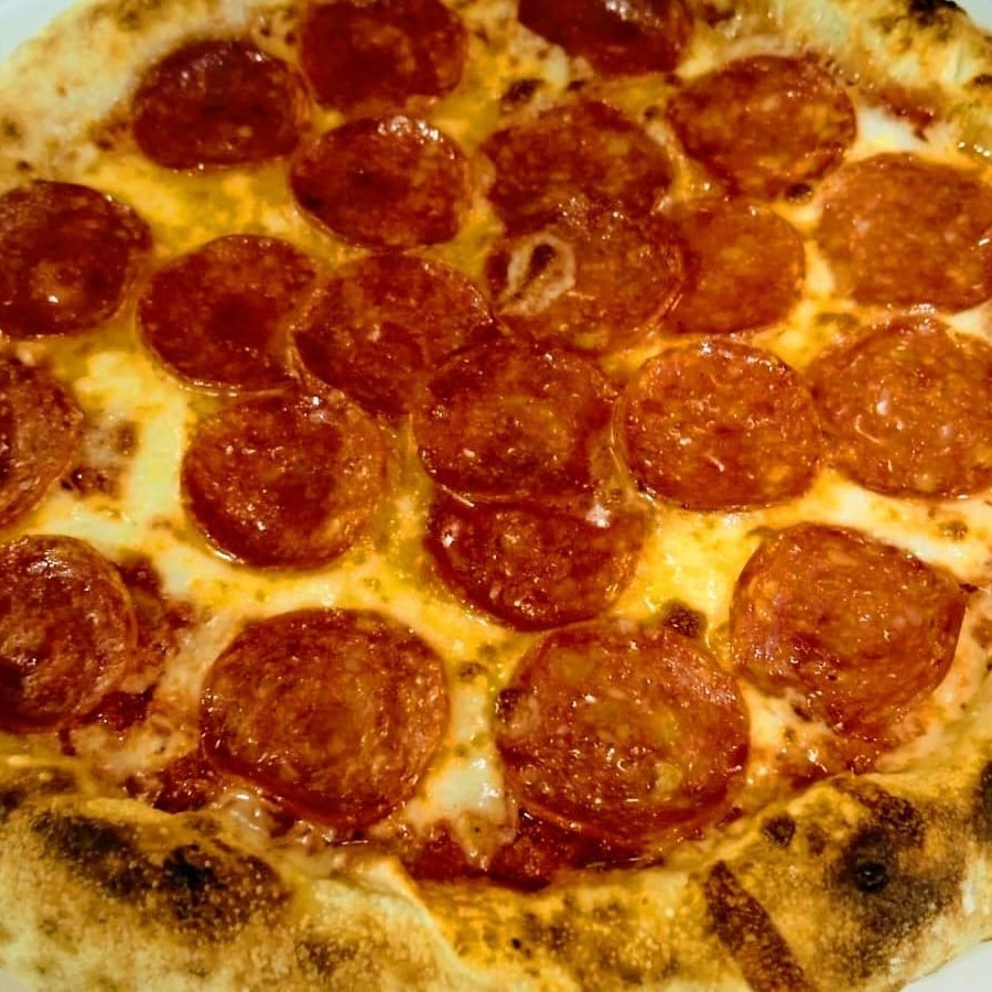 Experimente nossa deliciosa pizza artesanalcom molho de tomate pelati fresco, muçarela de búfala cremosa e fatias de peperroni.