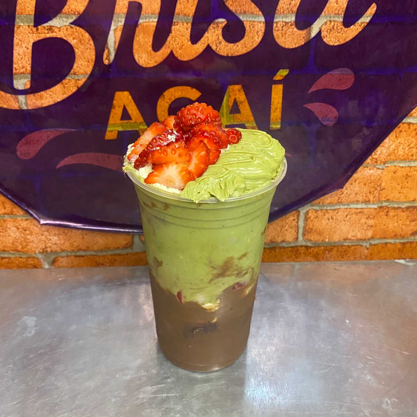 Açaí artesanal trufado com recheio de pistache e recheio de avelã, leite em pó integral e morangos frescos.
