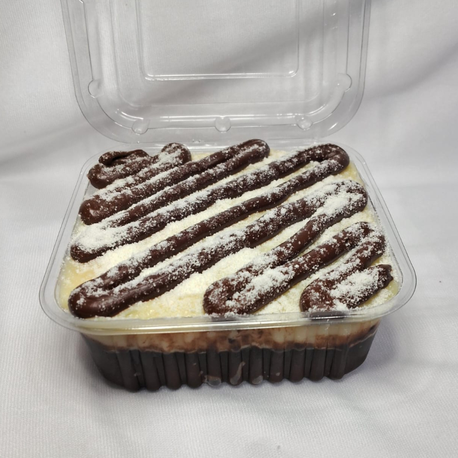 Bolo de chocolate 50% cacau molhadinho com calda de chocolate, recheio cremoso de leite Ninho com riscos de Nutella, finalizado com leite Ninho em pó.