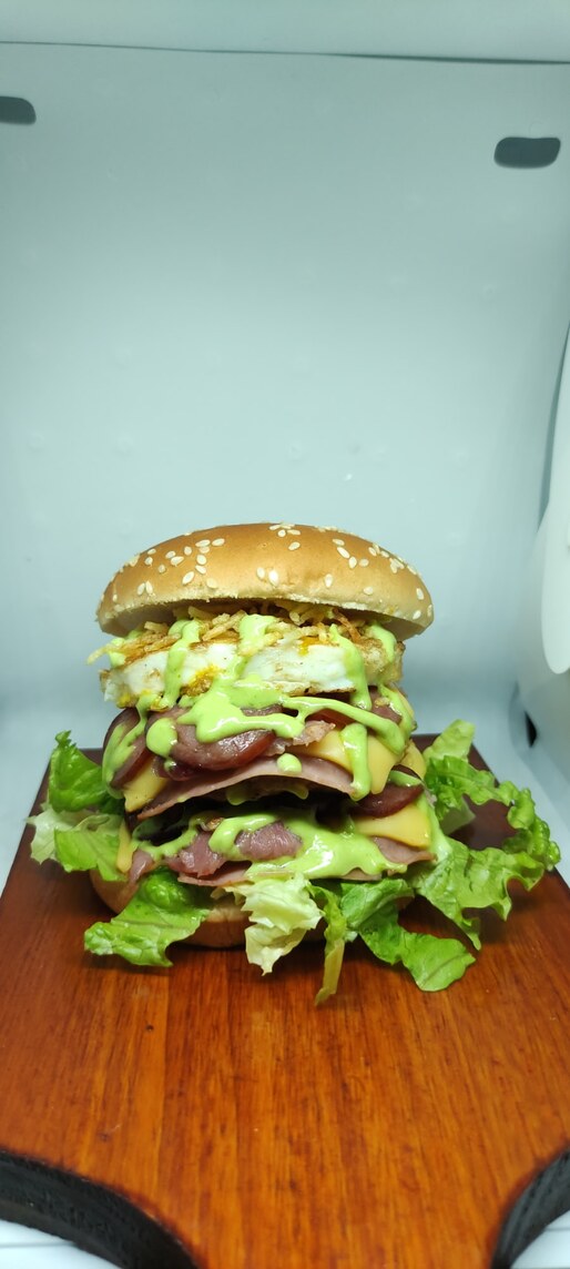 Pão 2 carnes , 2 ovos , 2 queijos  , 2 presuntos  , calabresas , bacon , salada , batata palha , ketchup  e molho verde .