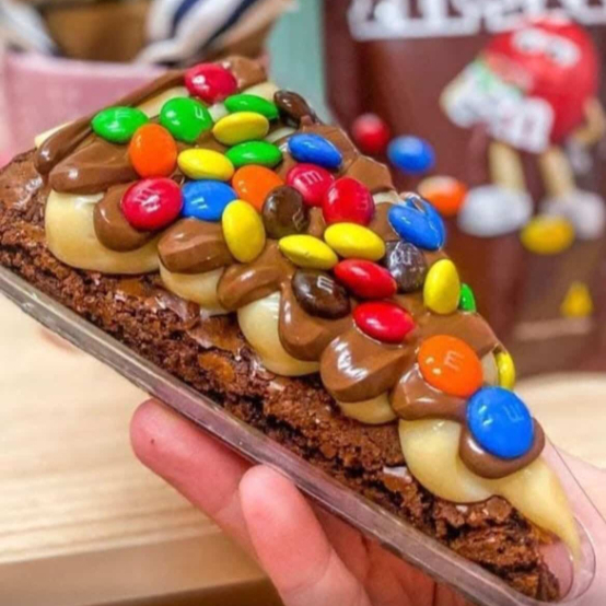 Massa molhadinha de brownie, coberto com ninho, nutella e mms