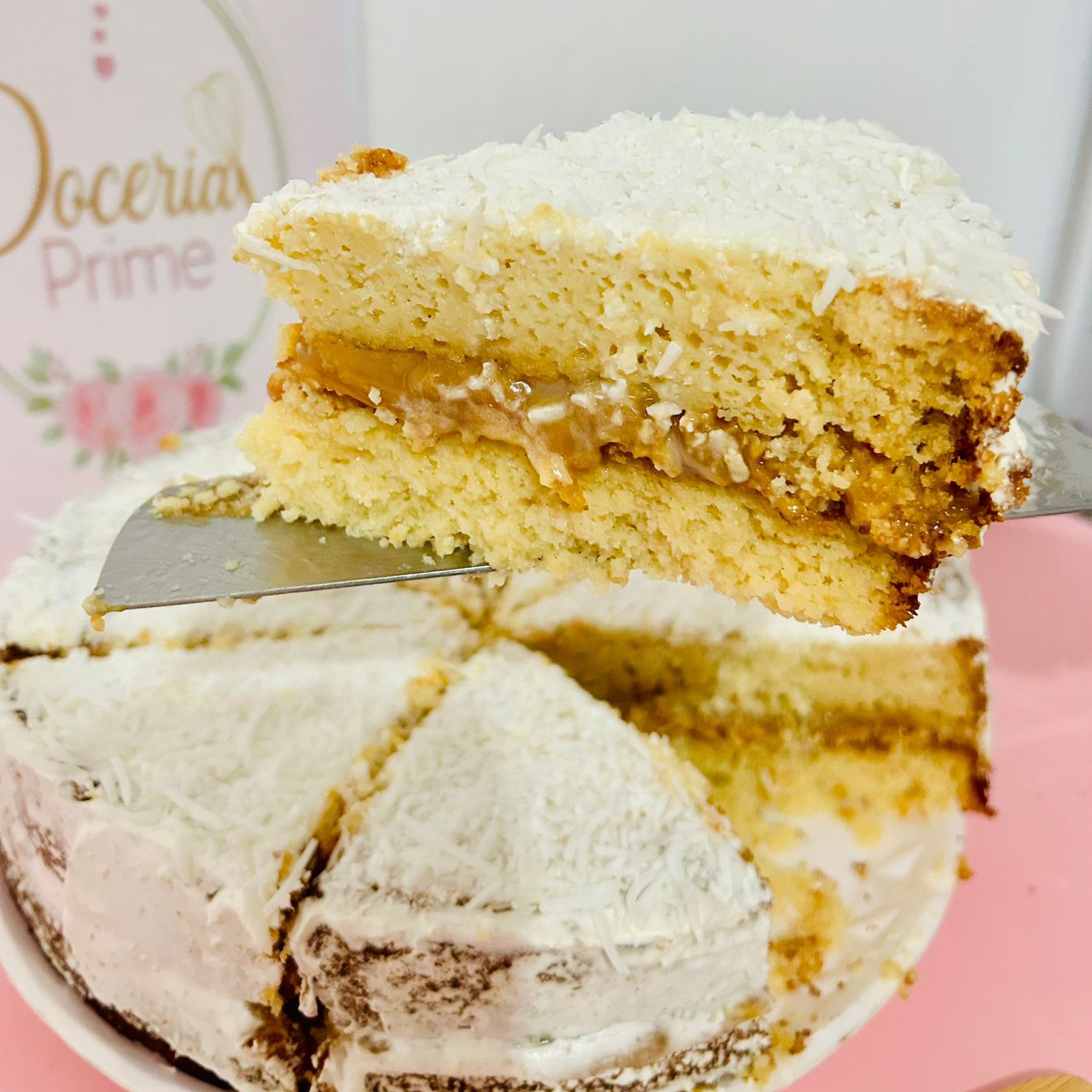 fatia de torta gelada, massa sabor baunilha com recheio de doce de leite com coco, coberto por uma fina camada de chantilly e coco em flocos.