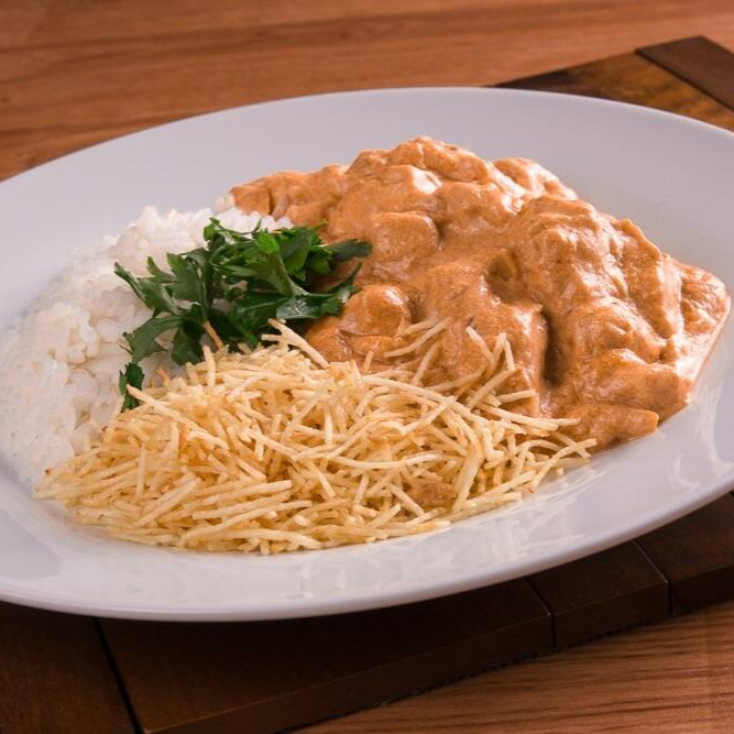 Tiras de frango super macias que acompanham arroz e batata palha.