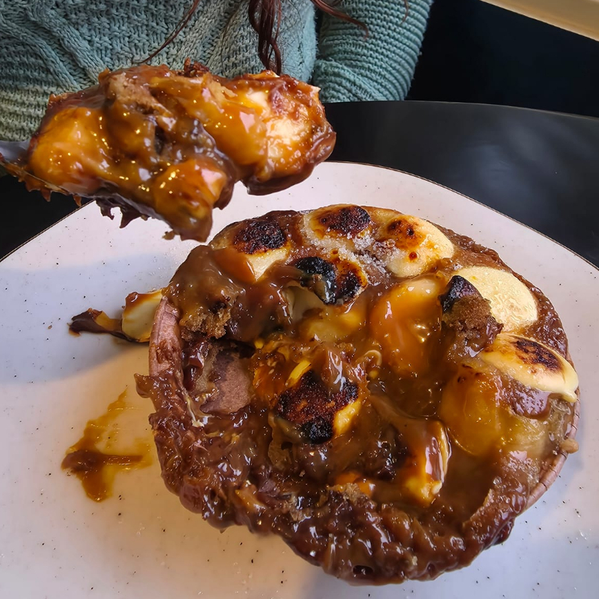 base de cookie, recheado com doce de leite, banana e chocolate branco. Assado na hora, tempo de preparo 20 min.