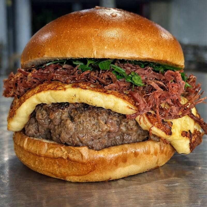 130g carne, pão chapeado na manteiga de garrafa, queijo coalho selado, charque desfiada e finalizado com melaço de cana.