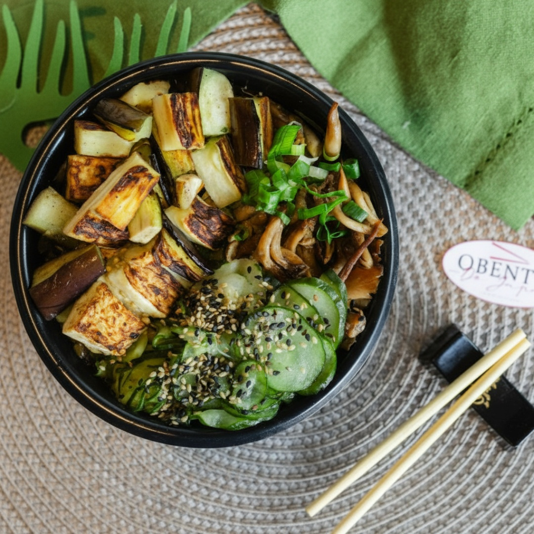 Bowl com cubos de beringelas , levemente temperadas e envoltas em uma crocante camada de farinha panko, escolha a base de arroz yakimeshi ou Gohan, acompanha pepino sunomono, cogumelos shimeji e a proteína empanada finalizada com cebolinha.
