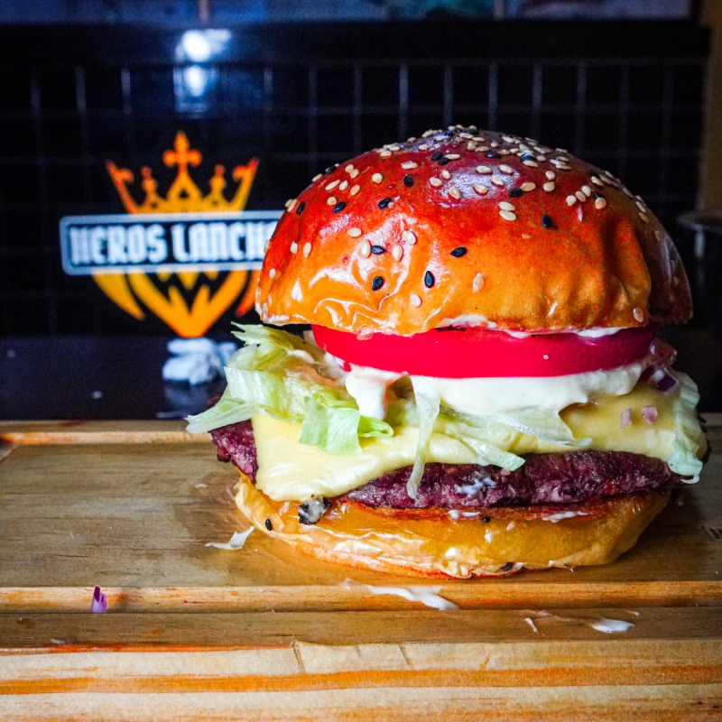 Pão Prime, Maionese alho, cebola rocha, 2 rodelas de tomate, alface, 1 smash. 80g c/ queijo