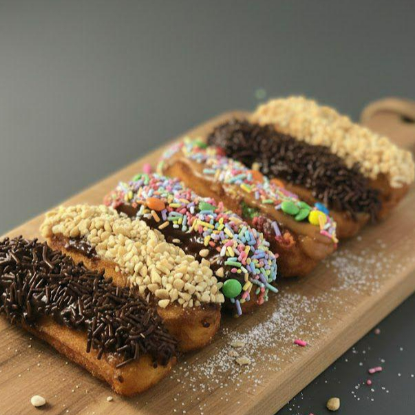 6 churros médios deitados com diversos sabores e cobertura a sua escolha.