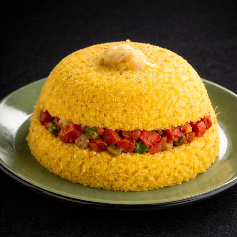 Cuscuz fofinho com carne seca desfiada e um leve toque de banana madura.