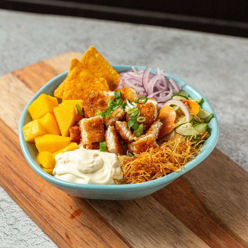 Base arroz Japonês, Pedacinhos de Manga em Cubos, Cebola Roxa, Pepino Fatiado, Chips de Batata, Cream Cheese, Doritos e Frango Empanado. Finalizado com Cebolinhas Frescas.