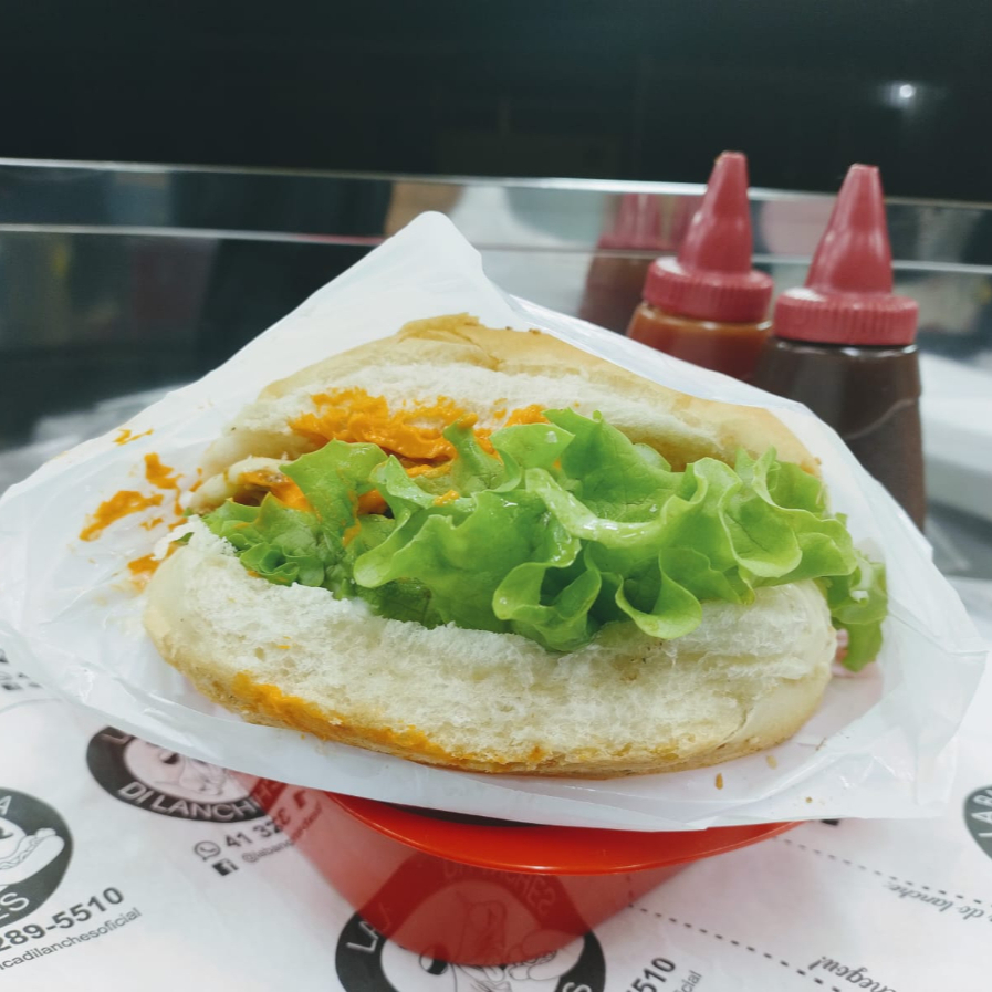 Pão, 1 hambúrguer de 90g, Maionese, Tomate, Milho, Alface, Alcatra com Cebola, Opção De Catupiry Ou Cheddar Ou Cream Cheese, Queijo E Presunto