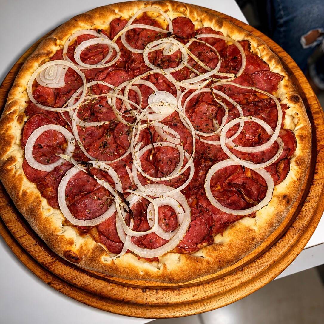 Molho de tomate, calabresa fatiada e cebola.