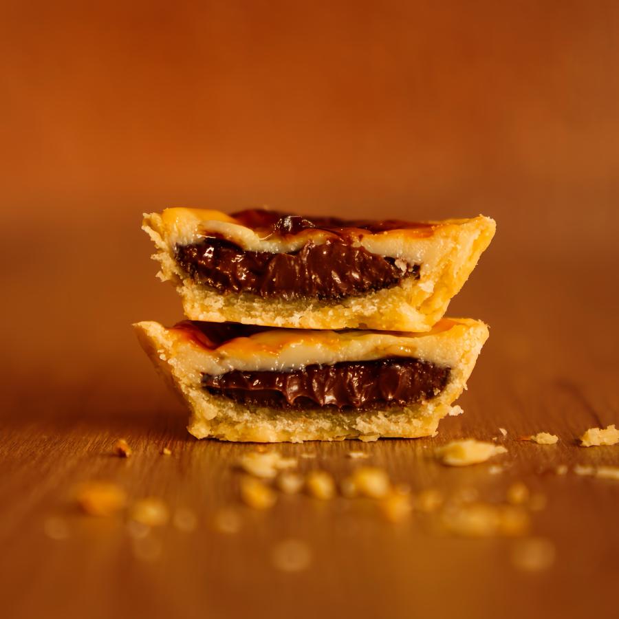 O encontro perfeito dos sabores mais amados da casa! De um lado, a cremosa empadinha de pudim; do outro, a irresistível empadinha de Nutella. Tudo isso junto e misturado numa só empada pra fazer seu coração bater mais forte! É o doce que conquista em dobro. ❤️🍮🍫✨