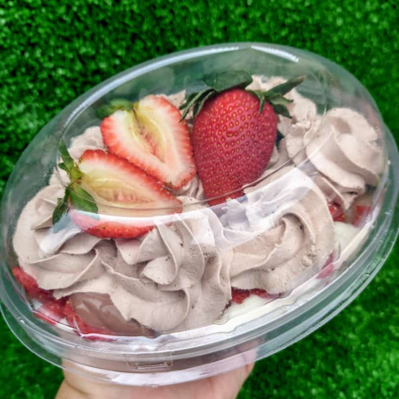 Creme de chocolate, brownie, morangos, creme 3 leites e chantilly de chocolate.