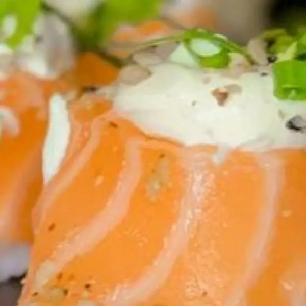 Salmão envolto no arroz, cream cheese e cebolinha.