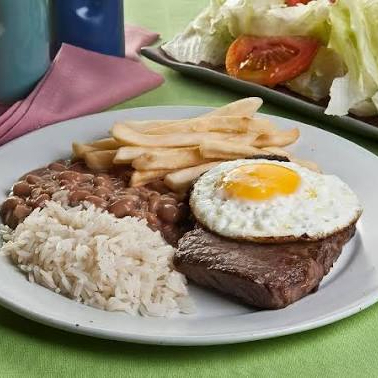 Bife de carne bovina assada e levemente amanteigada com ovo frito. Acompanha: Feijão Preto ou Mulato, Arroz, Batata frita, Salada e Farofa.