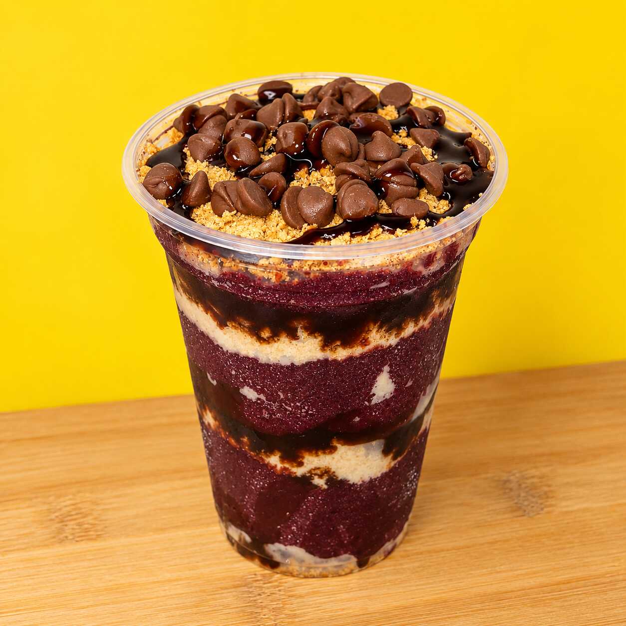 Açaí premium, gotas de chocolate, paçoca e calda de chocolate.
