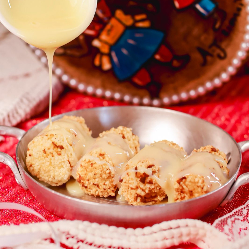 Punhetinhas Quatro mini bolinhos de tapioca frito, polvilhados na canela e açúcar, banhados no leite condensado