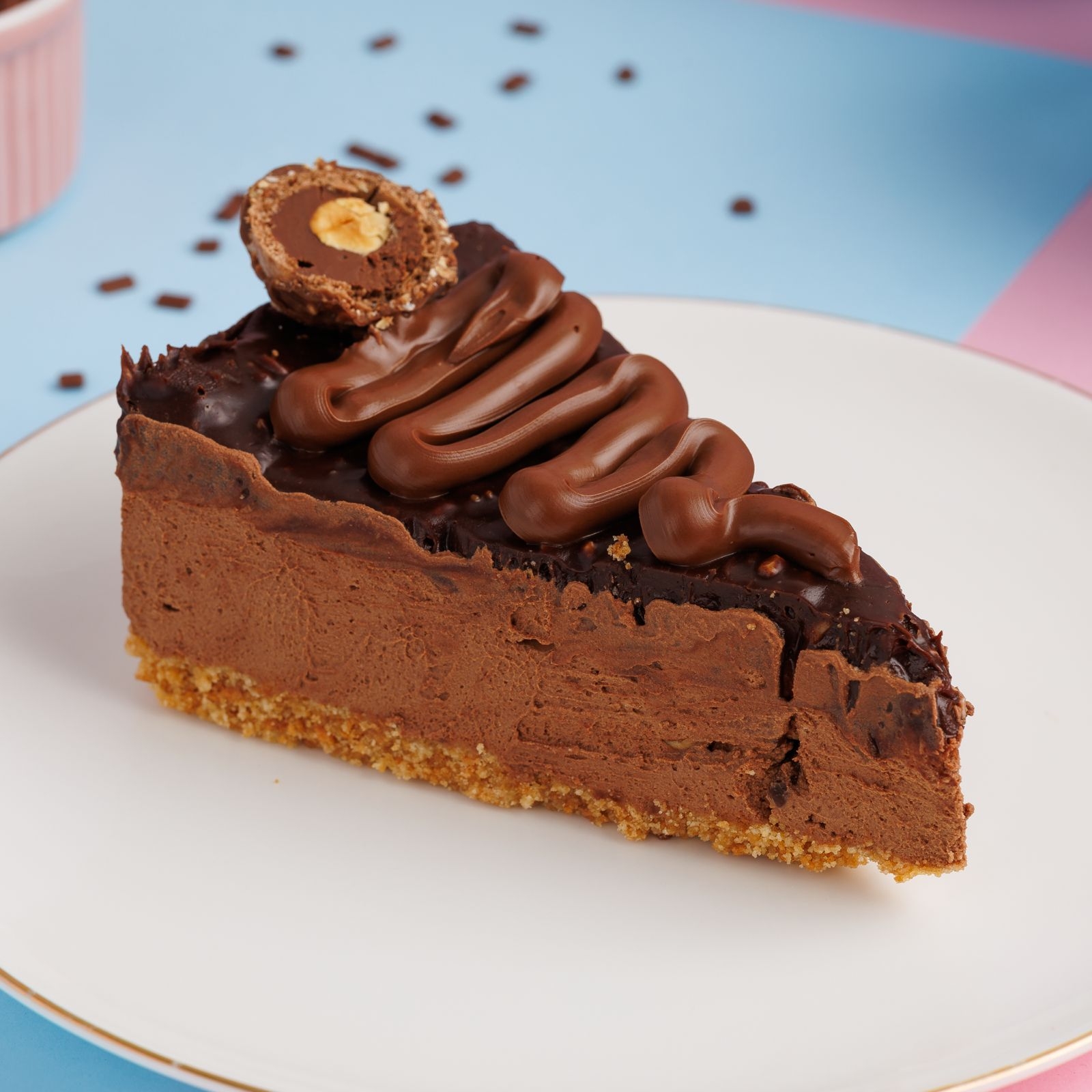 Massa a base de biscoito amanteigado, mouse cremoso feito com chocolate nobre meio amargo e creme de avelã coberto com uma deliciosa ganache crocante finalizado com Nutella pura e bombom Ferrero Rocher