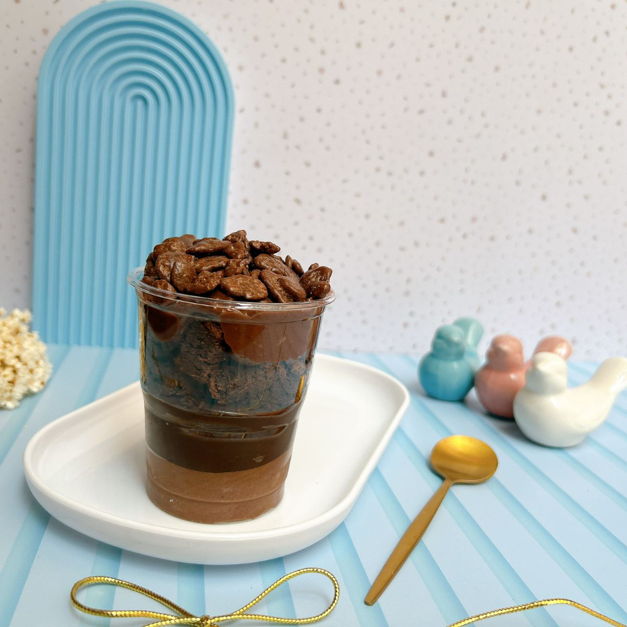 Camadas de mousse de chocolate, brigadeiro cremoso, brownie, pasta de Ovomaltine e Ovomaltine Rocks.