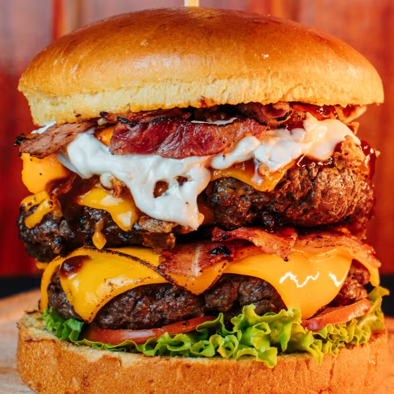 Irresistível Black Burguer é feito com 02 Burguers Artesanais (150g Cada), Cheddar Cremoso, Bacon Crocante, Cebola Caramelizada, Cebola Crispy, Alface, Tomate e Maionese Especial no Pão Brioche.