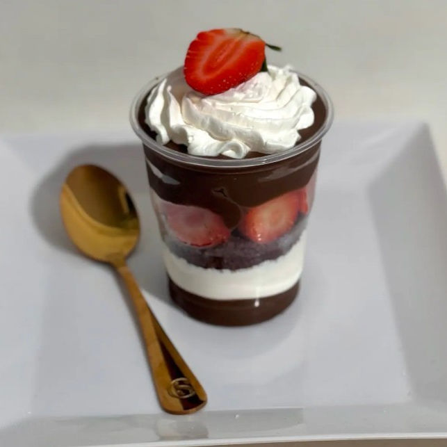 Com base de brigadeiro cremoso 50% cacau, mousse de ninho, intercalados com bolo de chocolate , morangos e finalizado com brigadeiro de chocolate.