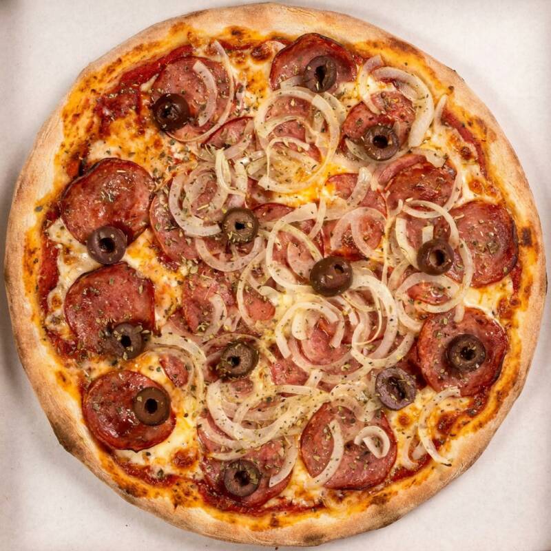 Massa fina artesanal, nosso molho de tomate, muçarela, calabresa, cebola, azeitona e óregano.