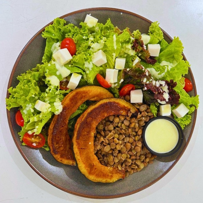 Lentilha, abóbora assada, queijo feta, tomatinho cereja, mix folhas e molho iogurte.